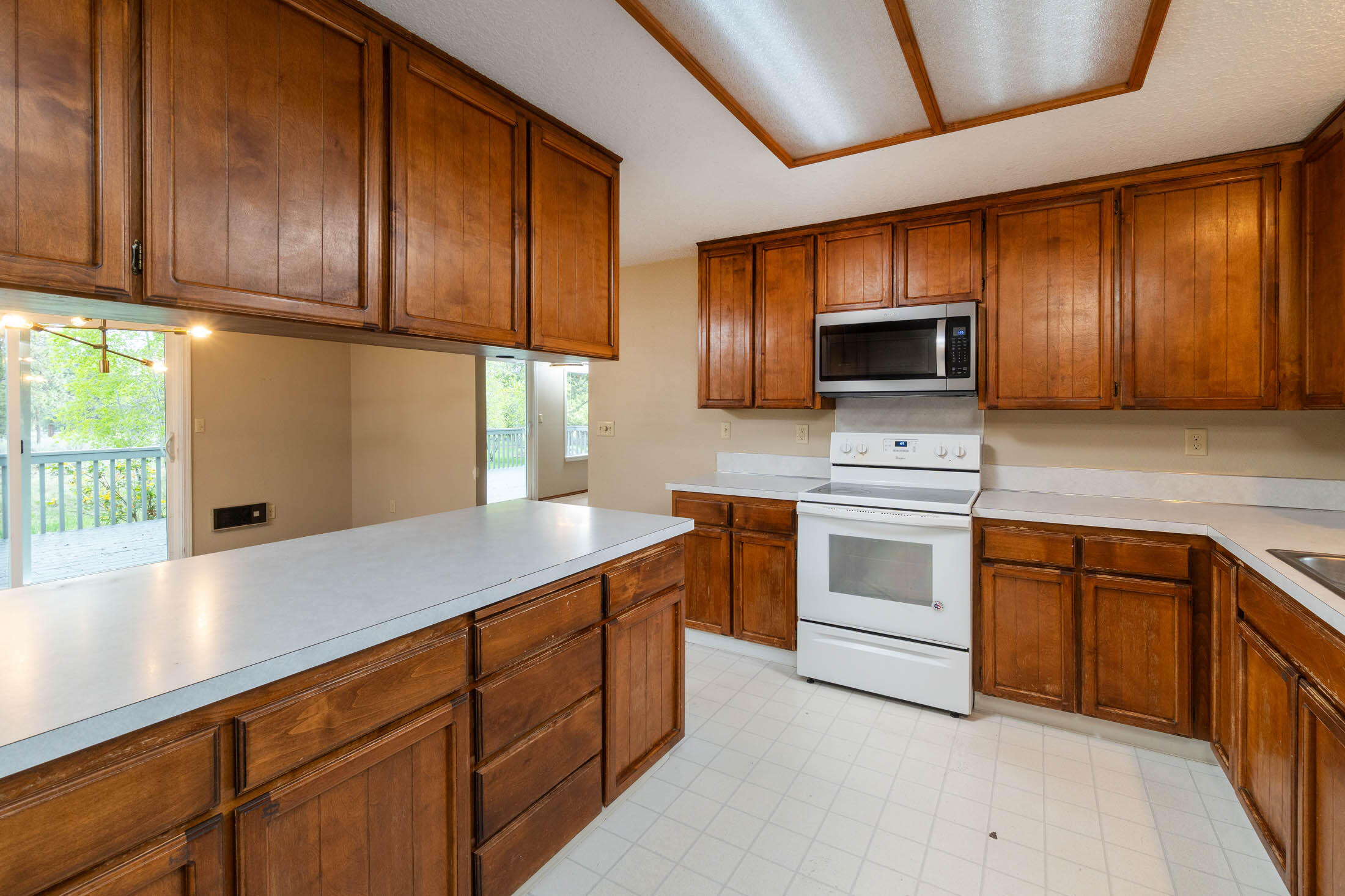 20316 Donkey Sled Road Bend, OR 97702 - Photo 7 of 50 a kitchen with stainless steel appliances granite countertop wooden cabinets a stove top oven a sink and dishwasher