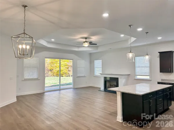 a view of a kitchen with a sink dishwasher and a fireplace