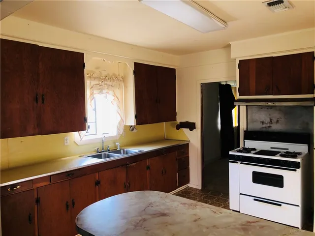 a kitchen with stainless steel appliances a stove microwave and refrigerator