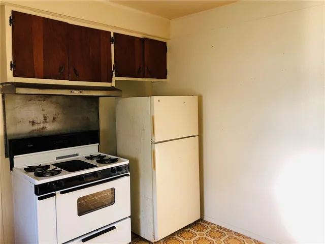 a stove top oven sitting inside of a kitchen