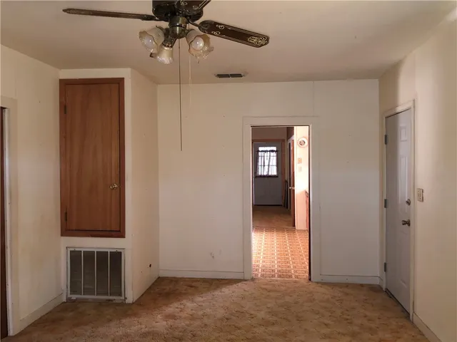 an empty room with closet and a bathroom