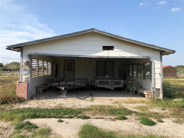 a view of a house with a yard and sitting area