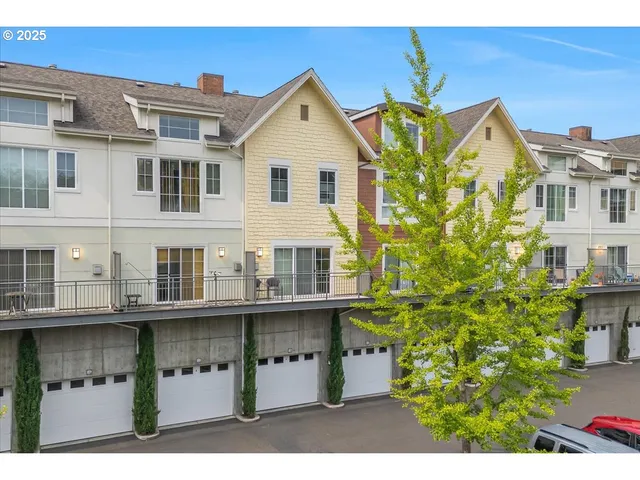 a view of a blue and white house with large windows