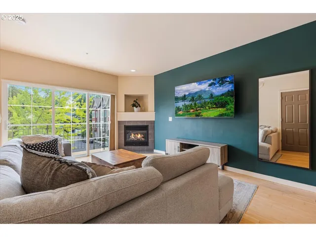 a living room with furniture a fireplace and a flat screen tv