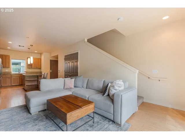 a living room with furniture and a view of kitchen