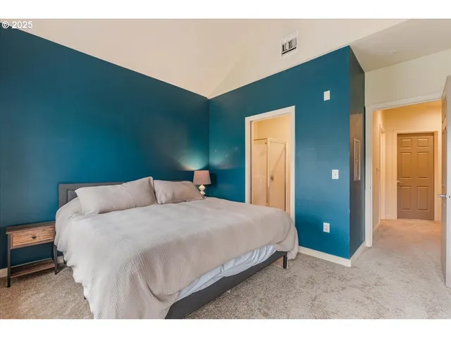 a bedroom with a bed and a lamp