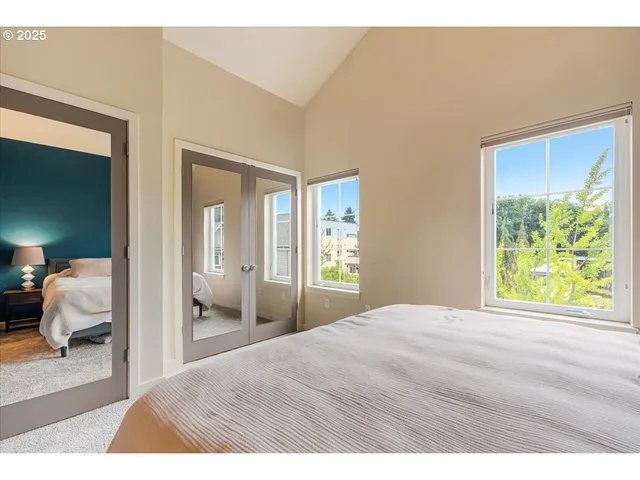 a bedroom with a bed and a large mirror