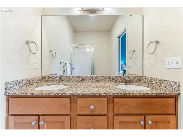 a bathroom with a granite countertop sink a mirror and a
