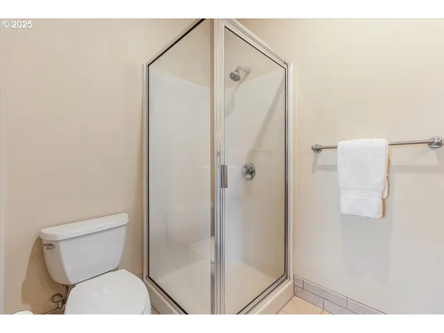 a bathroom with a toilet and a shower
