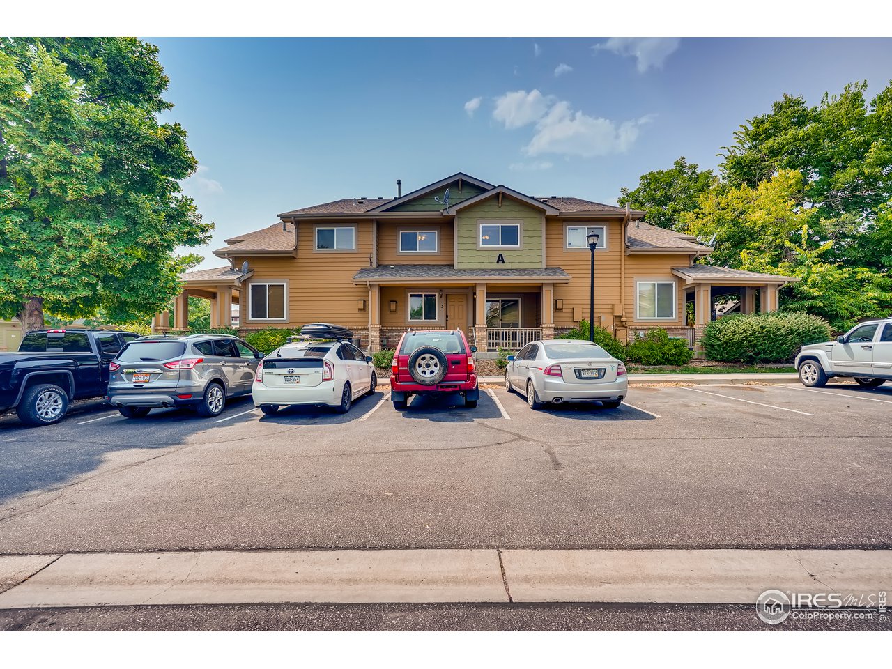a group of cars parked in front of a house