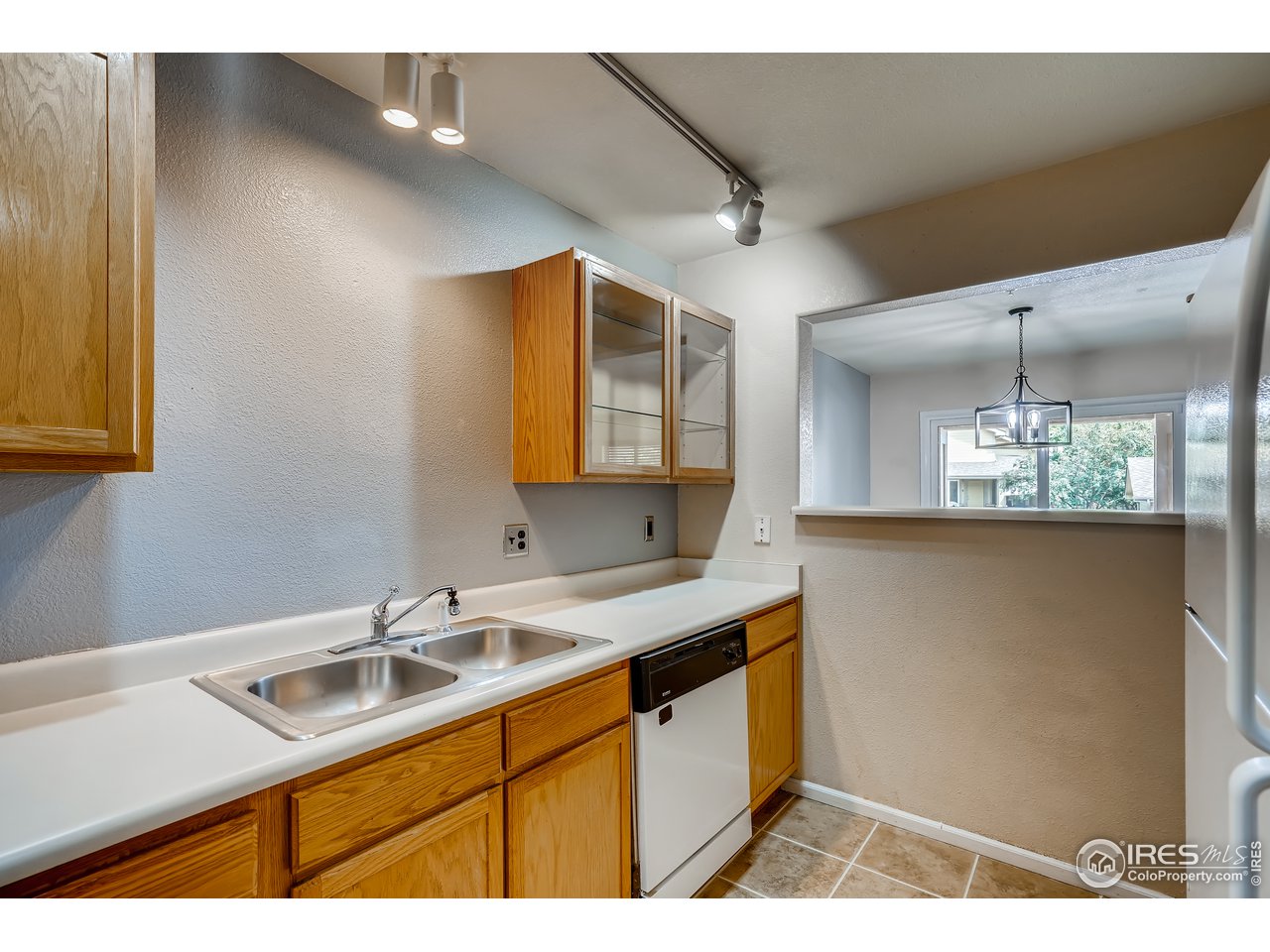 2702 Rigden Parkway, Unit A3 Fort Collins, CO 80525 - Photo 11 of 33 a kitchen with a sink a counter space and cabinets