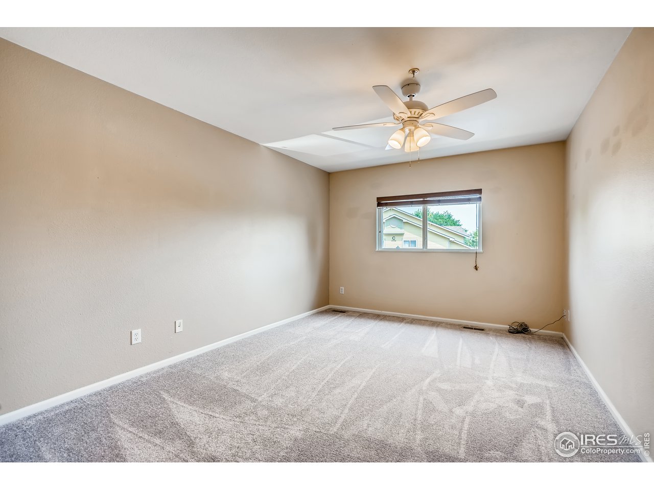 2702 Rigden Parkway, Unit A3 Fort Collins, CO 80525 - Photo 13 of 33 an empty room with windows and fan