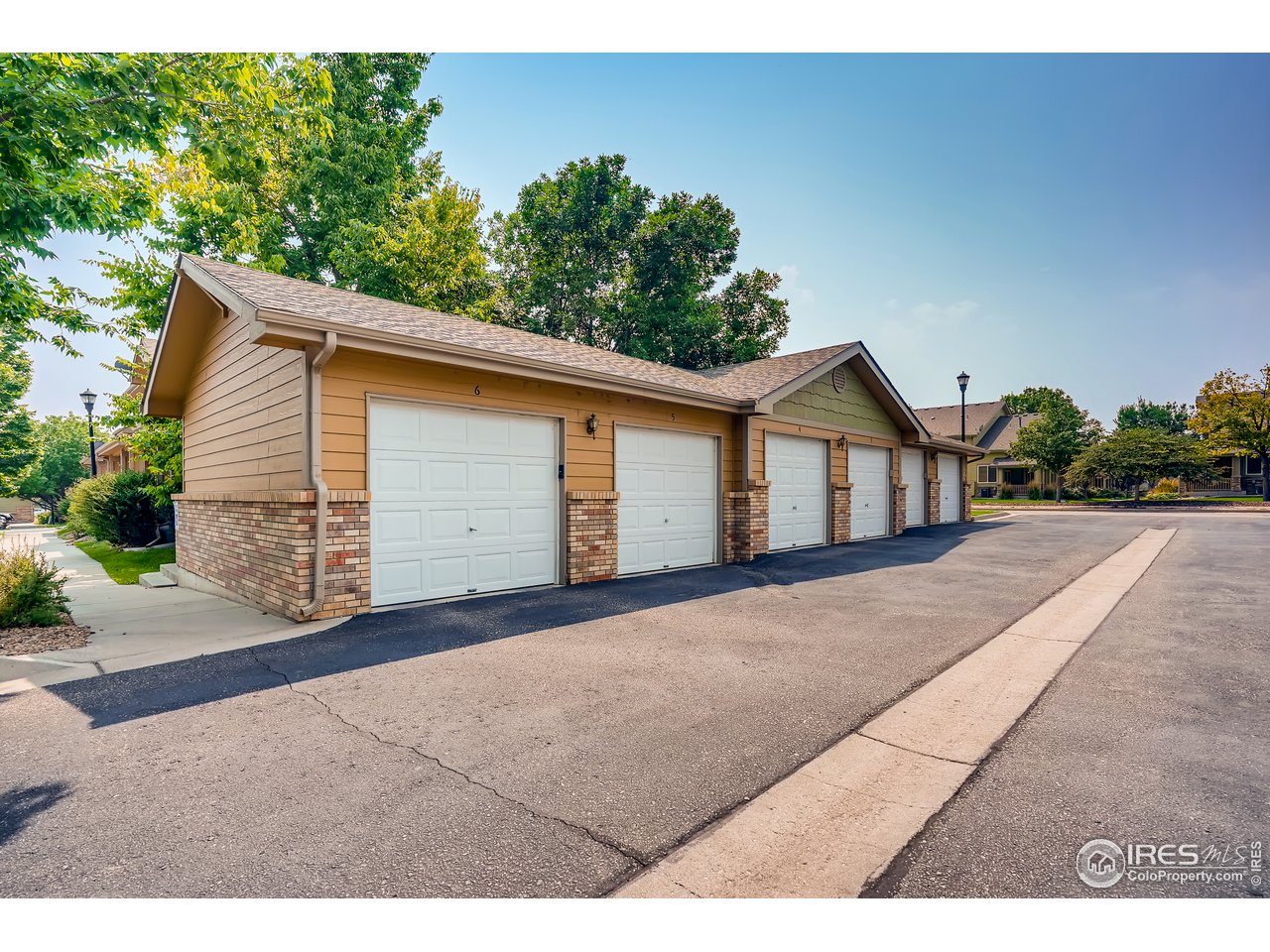 2702 Rigden Parkway, Unit A3 Fort Collins, CO 80525 - Photo 33 of 33 a front view of a house with a yard and garage