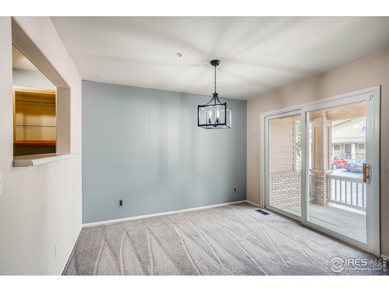 2702 Rigden Parkway, Unit A3 Fort Collins, CO 80525 - Photo 7 of 33 a view of an empty room with window and wooden floor