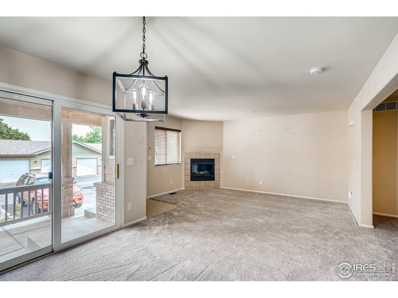 2702 Rigden Parkway, Unit A3 Fort Collins, CO 80525 - Photo 8 of 33 a view of empty room with wooden floor and fireplace