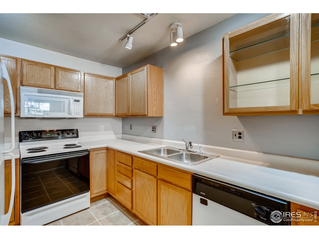 2702 Rigden Parkway, Unit A3 Fort Collins, CO 80525 - Photo 9 of 33 a kitchen with a sink stove and microwave