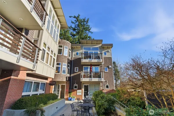 a front view of a residential apartment building with a yard