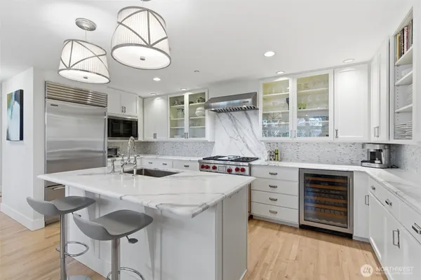 a kitchen with a sink stove and cabinets