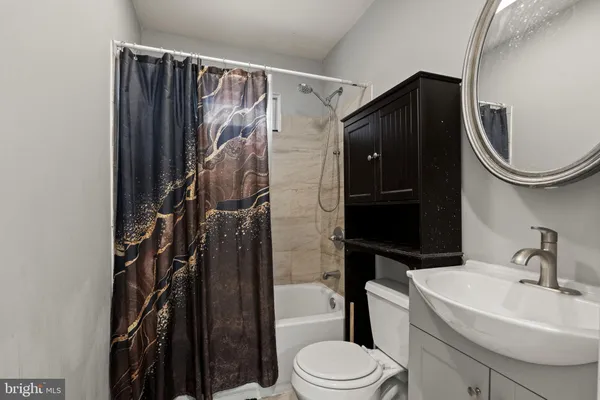 a bathroom with a toilet a sink and bathtub