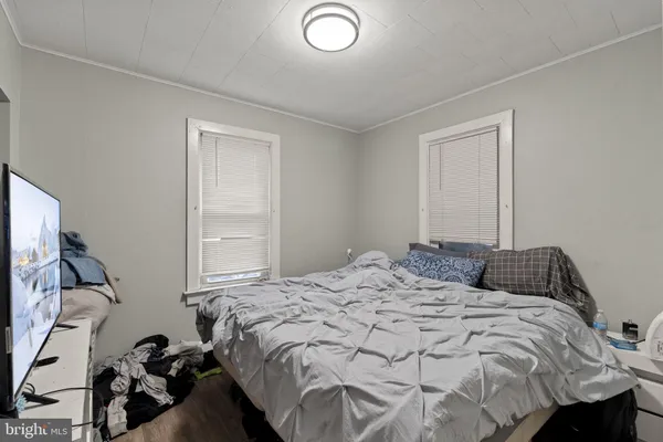 a bedroom with a bed and a flat tv screen