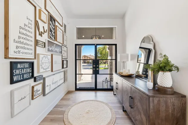 a living room with furniture a mirror and a table