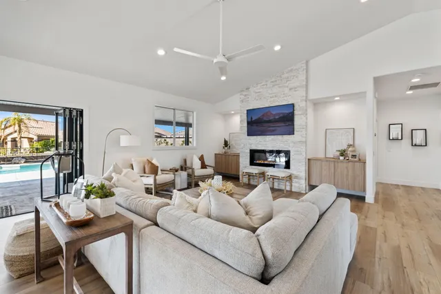 a large white kitchen with stainless steel appliances