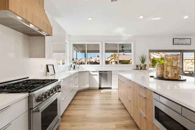 a bathroom with a granite countertop bathtub shower and toilet