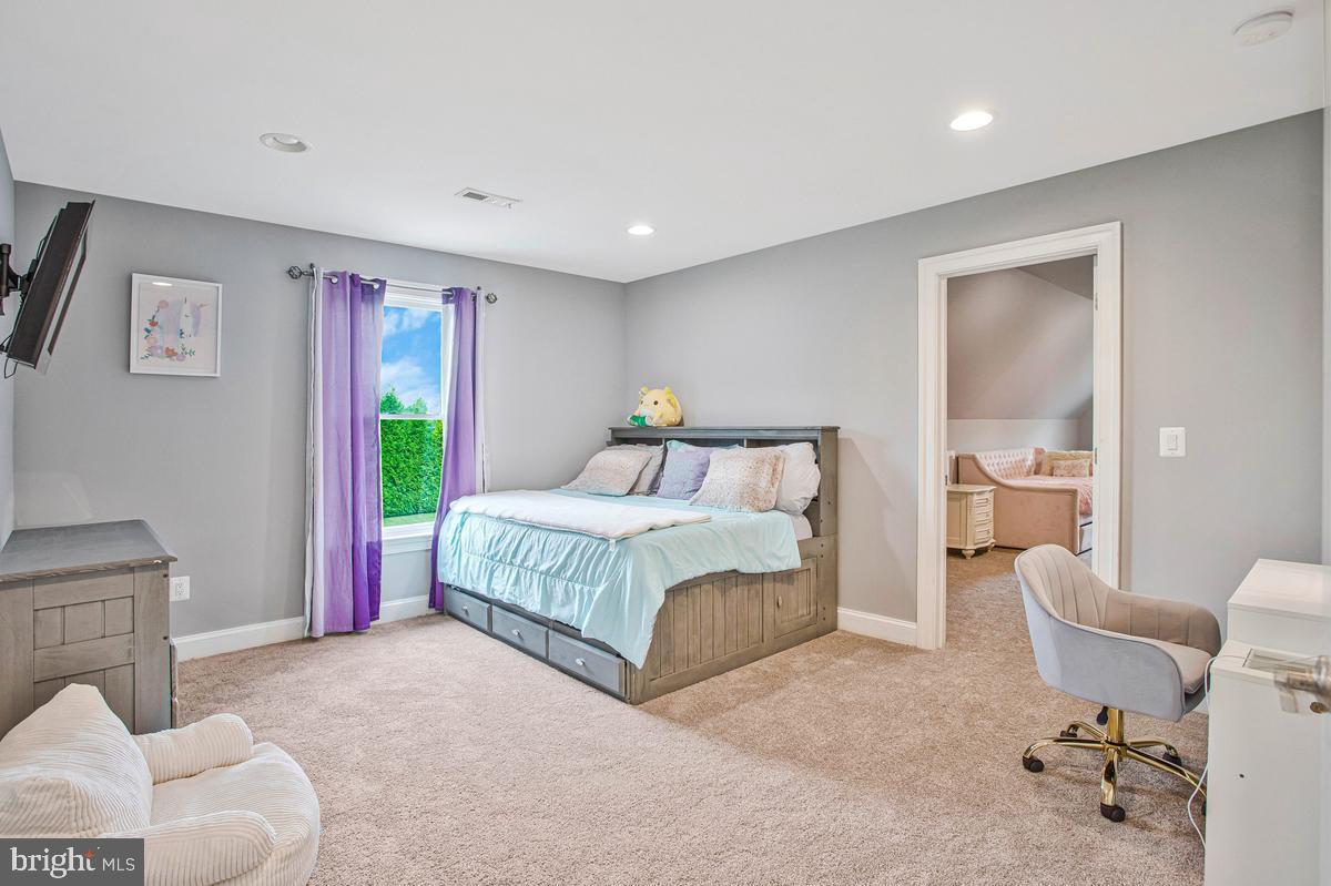 5 Jessie Road Harwood, MD 20776 - Photo 49 of 87 a spacious bedroom with a bed and a couch