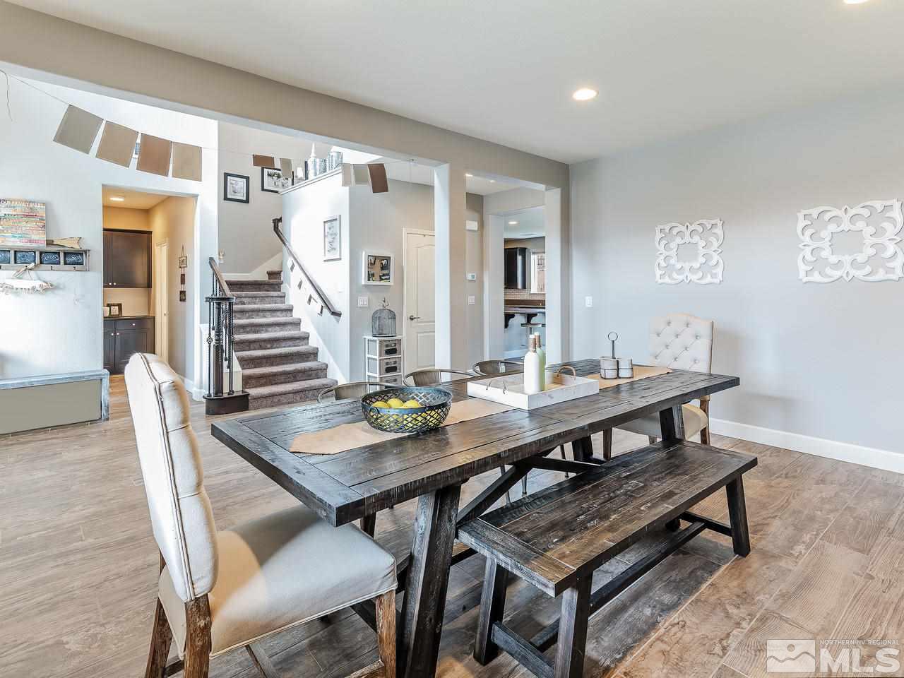 10140 Barrel Racer Drive Reno, NV 89521 - Photo 3 of 24 a view of a dining room with furniture and wooden floor