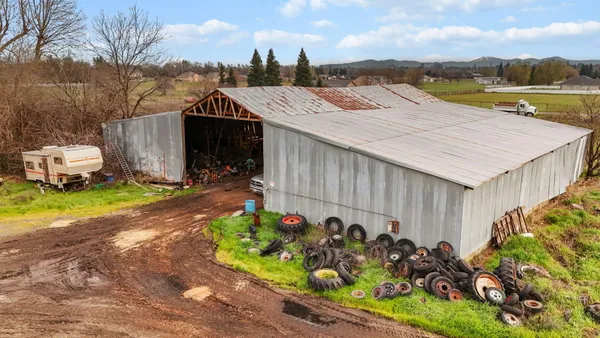 a view of a house with a yard and plants