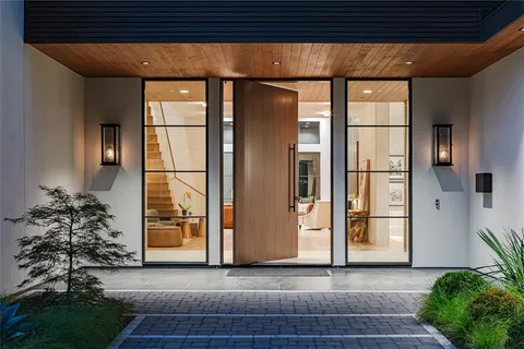 a view of front door with potted plants