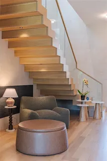 a living room with furniture and a lamp