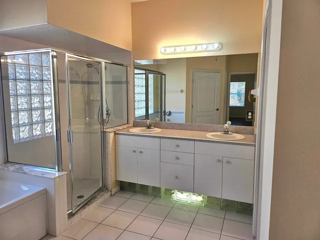 a spacious bathroom with a mirror a sink and a mirror