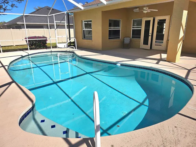 a view of a backyard with a swimming pool