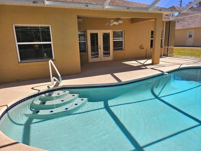a room with pool table and windows
