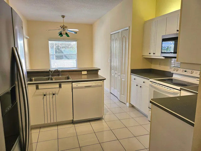 a kitchen with stainless steel appliances a sink stove and refrigerator