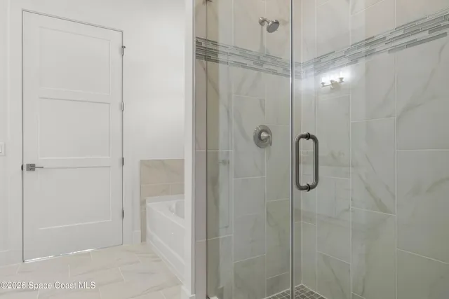 a bathroom with a glass shower door