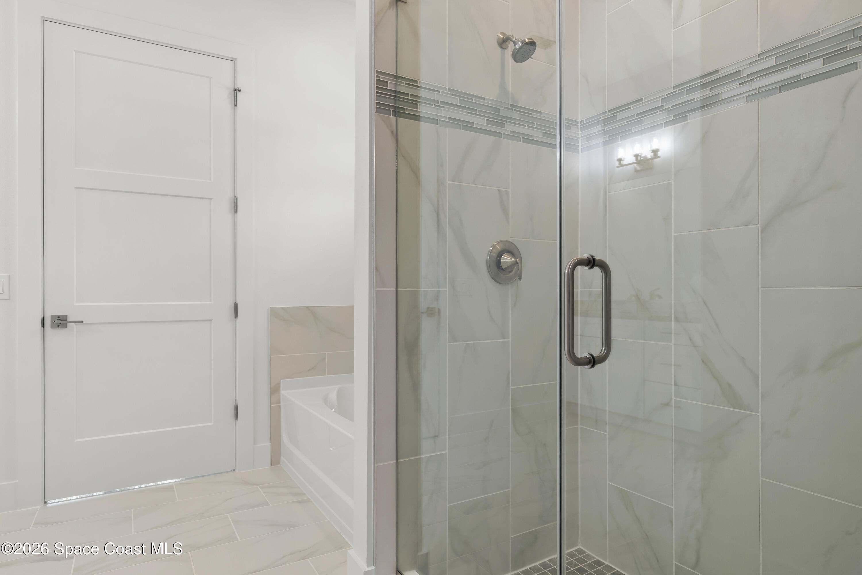 655 Vine Street Melbourne, FL 32904 - Photo 23 of 33 a bathroom with a glass shower door