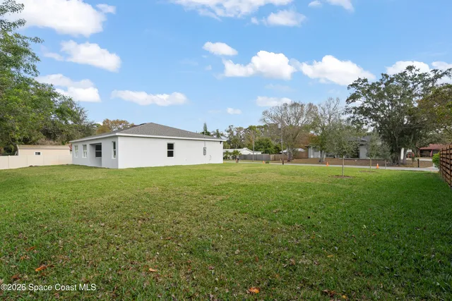 a front view of house with yard and trees
