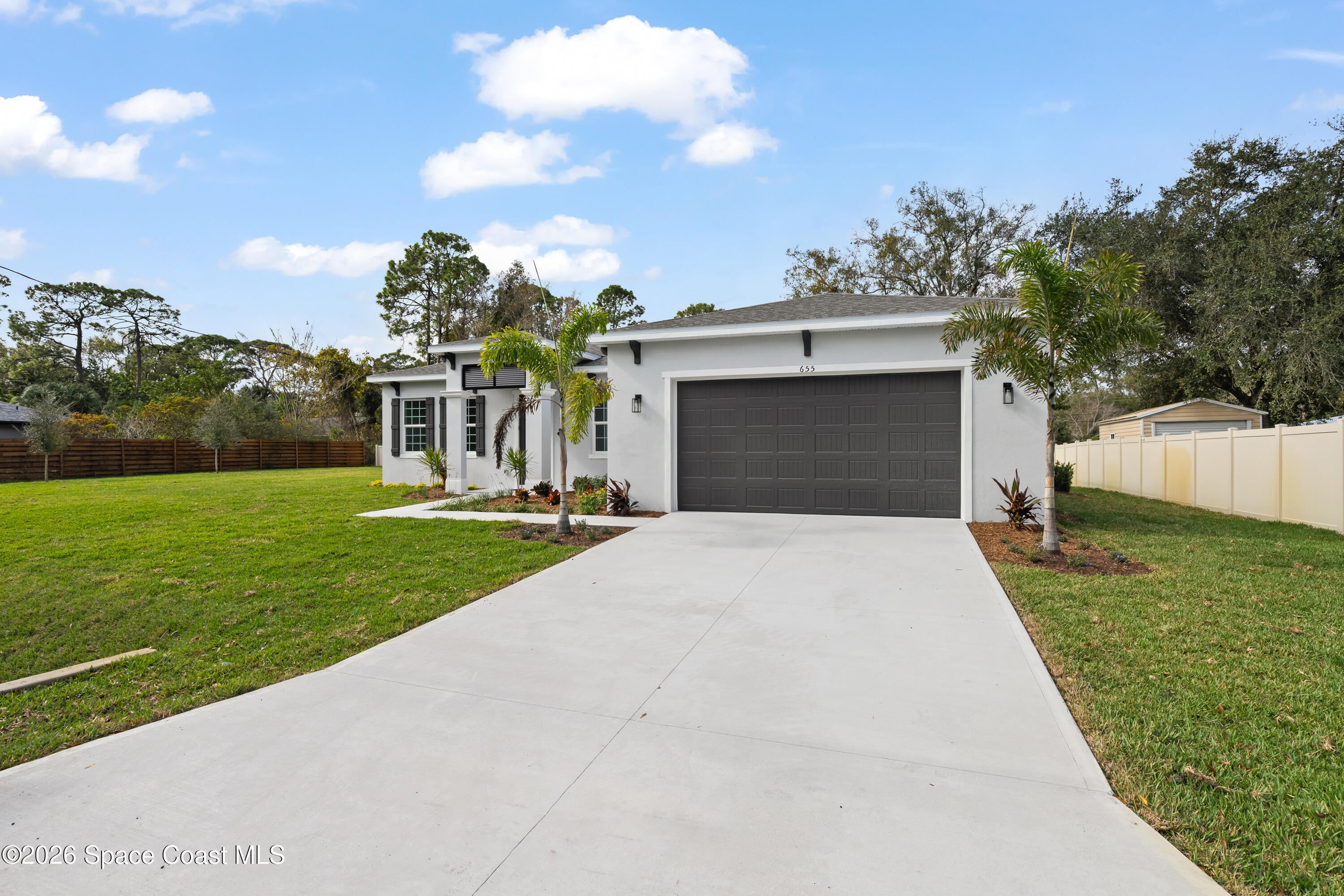 655 Vine Street Melbourne, FL 32904 - Photo 4 of 33 a front view of a house with a yard and garage