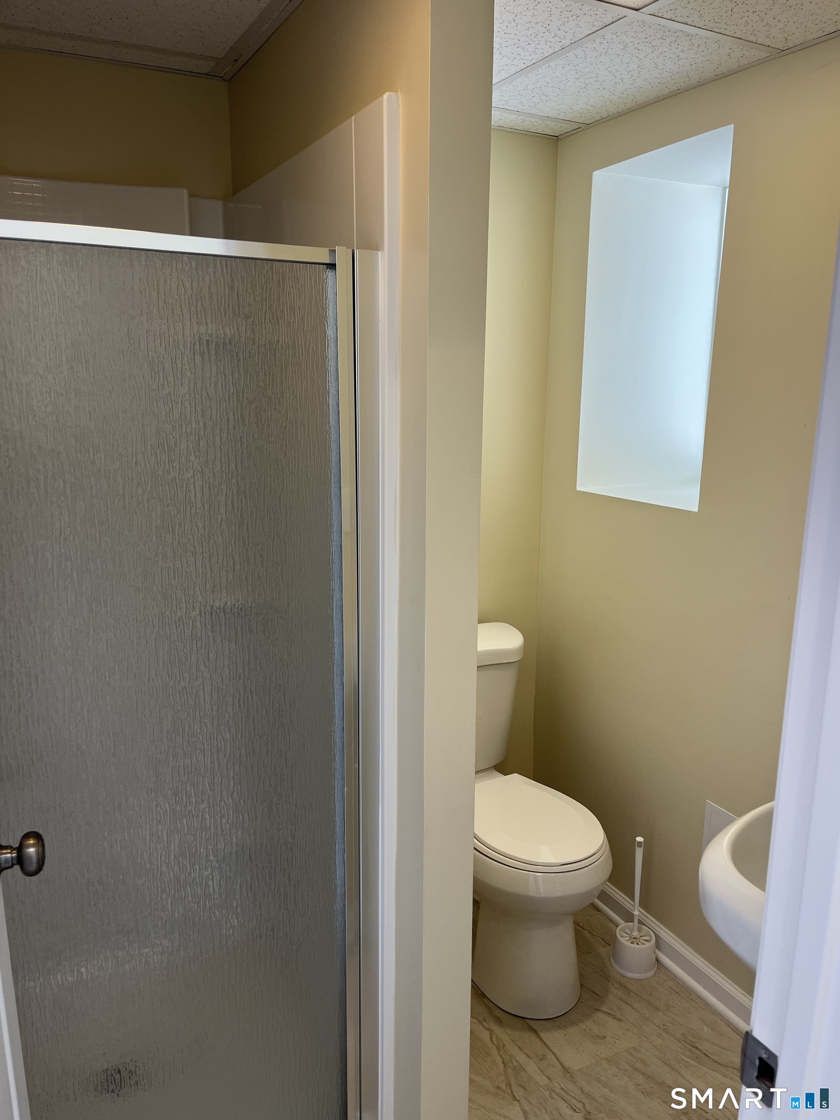 49 New Street Seymour, CT 06483 - Photo 5 of 6 a white toilet sitting next to a shower