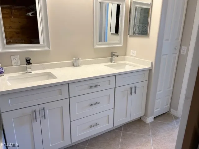 a bathroom with a double vanity sink and mirror