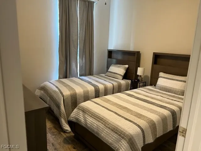 a bedroom with two beds and a chair