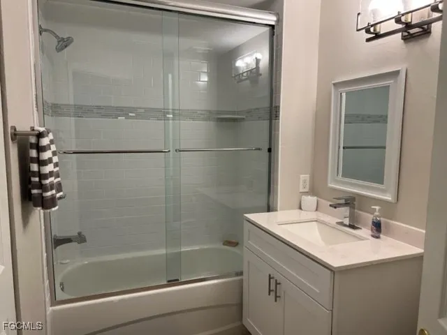a bathroom with a bathtub shower sink vanity and toilet
