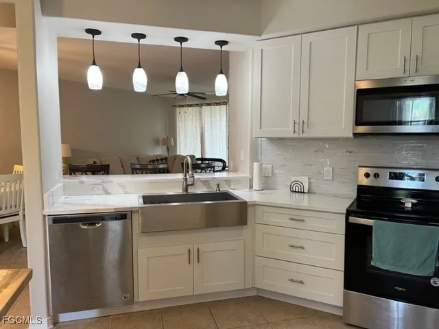 a kitchen with cabinets appliances and a sink