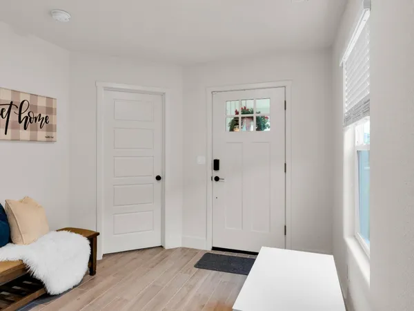 a view of a bedroom with furniture and wooden floor