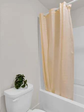 a bathroom with a sink toilet and a window