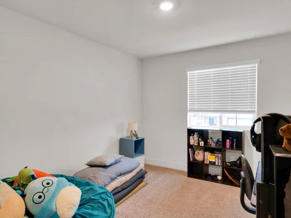 a bedroom with furniture and a window