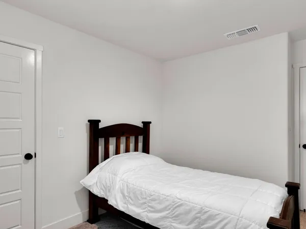 a bedroom with a bed and a table