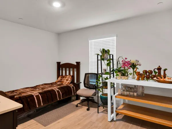 a bedroom with furniture and a potted plant